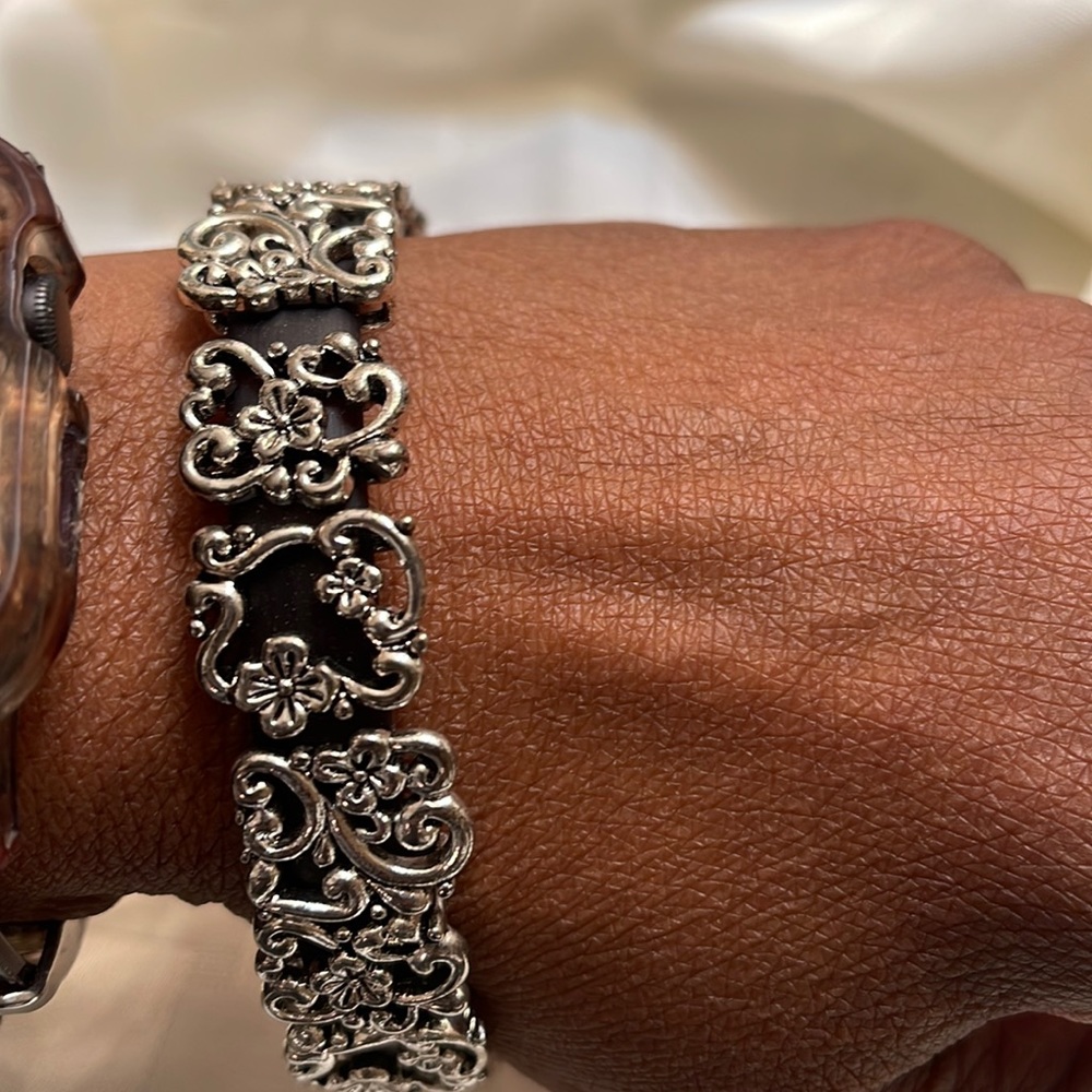 Silver tone and brown plastic band bracelet used